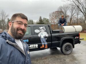 Two of our workers pose in front of our official pickup truck.