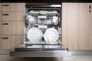 An open built-in dishwasher filled with clean dishes